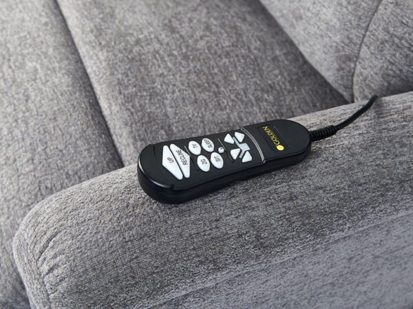 A Comforter with MaxiComfort Large in black, featuring buttons, rests on a gray upholstered chair arm.