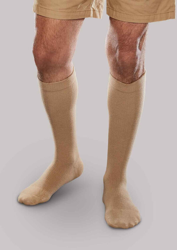 Person wearing Core-Spun 20-30 mmHg compression socks and khaki shorts against a neutral background.