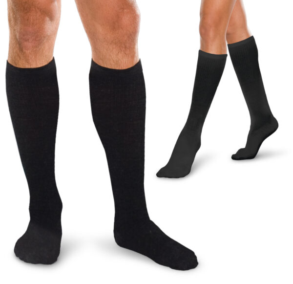 Two pairs of legs are wearing Core Spun 15-20 mmHg knee-high black socks. One pair features muscular legs with visible hair, while the other pair has sleek, hairless legs.